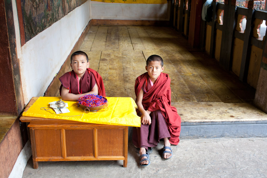 Boy monks at the entrance of a temple in Paro Dzong
